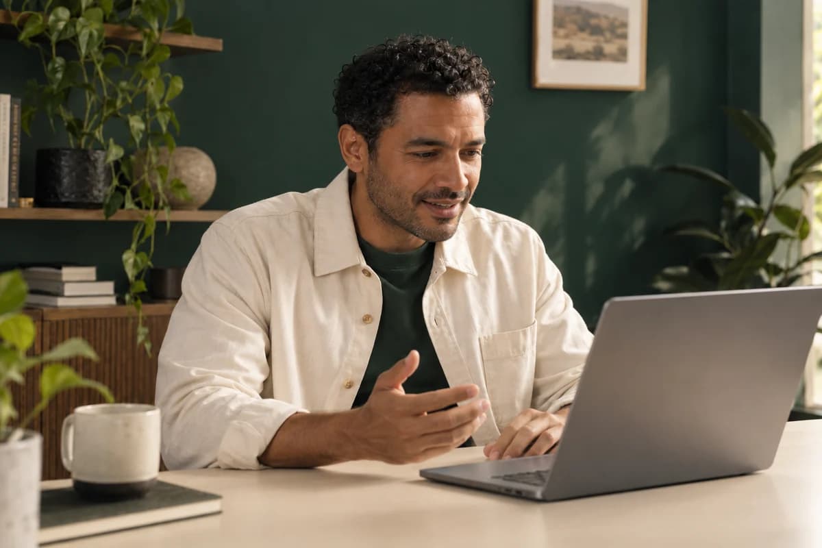 The same business owner having a conversation on his laptop